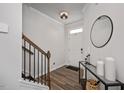 Bright entryway with hardwood floors, staircase, and console table at 816 Summer Bloom Ct, Durham, NC 27703