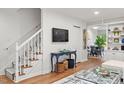 Living area with staircase, built-ins, and TV at 3738 Yorktown Pl, Raleigh, NC 27609