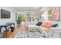 Bright living room with sectional sofa, built-in shelving, and hardwood floors at 3738 Yorktown Pl, Raleigh, NC 27609