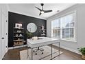 Bright home office features built-in shelving and large window at 3086 Wishing Well Wynd Wynd, Apex, NC 27502