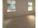 Empty bedroom with two windows, ready for finishing touches at 7120 Hubner Pl # 38, Cary, NC 27519