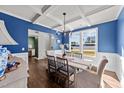 Bright dining room with blue walls and a farmhouse style table at 8901 Brook Trout Ln, Willow Springs, NC 27592