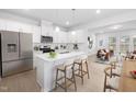 Modern kitchen with white cabinets, island, and breakfast area at 2840 Huxley Way, Apex, NC 27502