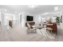 Spacious bonus room with stylish furniture and a large TV at 2884 Huxley Way, Apex, NC 27502