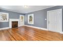 Spacious living room with hardwood floors, fireplace, and gray walls at 619 N Mebane St, Burlington, NC 27217