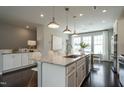 Modern kitchen with white cabinets, granite island, and stainless steel appliances at 2341 Bay Minette Sta # 555, Apex, NC 27502