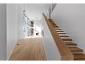 Modern staircase with light wood and open floor plan at 1208 Wimbleton Dr, Raleigh, NC 27609