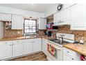 Bright kitchen with white cabinets, tile countertops, and modern appliances at 1717 Martin Luther King Dr, Rocky Mount, NC 27801