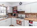 Bright kitchen with white cabinets, tile countertops, and modern appliances at 1717 Martin Luther King Dr, Rocky Mount, NC 27801