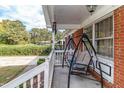 Relaxing front porch with a swing, perfect for enjoying the outdoors at 1717 Martin Luther King Dr, Rocky Mount, NC 27801