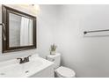 Updated bathroom with white vanity, shower, and tiled walls at 611 W Ivey St, Lillington, NC 27546