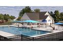 Community pool with cabana and surrounding seating at 32 Blue Iris Parkway, Clayton, NC 27520