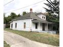 White clapboard house with porch needs some TLC at 313 E Umstead St, Durham, NC 27707