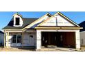 Newly constructed home with a two-car garage and dormer window at 180 Brunswick Dr, Nashville, NC 27856