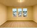 Bright bedroom with neutral carpeting and large windows offering a view at 20 Nettle Ln # 239, Clayton, NC 27520