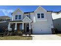 Two-story home with white siding, brick accents, and a two-car garage at 445 Edison Rail Ln, Knightdale, NC 27545