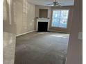 Bright living room featuring a fireplace and large window at 4429 Log Cabin Dr, Raleigh, NC 27616