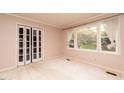 Living Room with large window and bi-fold doors at 1 Westbury Pl, Durham, NC 27707