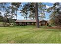 Brick ranch house with a large front yard and mature trees at 739 Silk Hope Lindley Mill Rd, Siler City, NC 27344