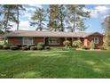 Brick ranch house with mature landscaping and large yard at 739 Silk Hope Lindley Mill Rd, Siler City, NC 27344
