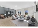 Spacious living room with a sectional sofa, large windows and hardwood floors at 1510 Village Hall Ln # 44, Wake Forest, NC 27587