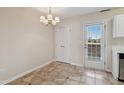 Small dining area with tile floors and access to a patio at 2129 Ventana Ln, Raleigh, NC 27604