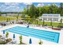 Community lap pool with surrounding lounge area at 2213 Pitchfork Ln, Durham, NC 27713