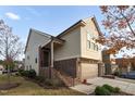 Side view of tan and brown brick townhome at 1203 Lotus Lilly Dr, Durham, NC 27713
