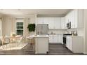 Modern kitchen with white cabinets, an island, and stainless steel appliances at 0 Hanover Dr, Sanford, NC 27330