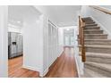 Bright hallway with wood floors, staircase, and closet at 1321 Dylan Heath Ct, Raleigh, NC 27608