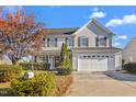 Two-story house with gray siding, landscaping, and a two-car garage at 102 Redstone Dr, Gibsonville, NC 27249