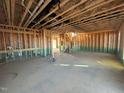 An open floor plan with exposed framing, plumbing, and electrical work at 1073 Channel Drop Lp, Zebulon, NC 27597