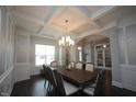 Bright dining room with hardwood floors, chandelier, and access to the kitchen at 3053 Thurman Dairy Loop, Wake Forest, NC 27587