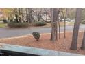 View of a tree-lined street and apartment buildings at 311 Ashley Forest Rd # Bldg E, Chapel Hill, NC 27514