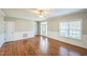 Hardwood floors, fireplace, and neutral walls grace this spacious living room at 242 Great Oak Dr, Garner, NC 27529