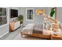 Virtually staged bedroom with a comfortable bed and plenty of natural light at 615 Wildaro Ct, Hillsborough, NC 27278