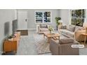 Virtually staged living room featuring comfortable seating and a stylish coffee table at 615 Wildaro Ct, Hillsborough, NC 27278