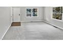Bright living room with neutral carpeting and ample natural light at 615 Wildaro Ct, Hillsborough, NC 27278