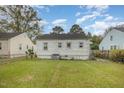 Spacious backyard with a grassy area and neighboring houses visible at 1226 W Thomas St, Rocky Mount, NC 27804