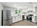 Modern kitchen with white cabinets, stainless steel appliances, and granite countertops at 509 Keith St, Knightdale, NC 27545