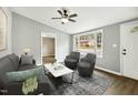 Spacious living room with gray walls, dark furniture, and large windows at 509 Keith St, Knightdale, NC 27545