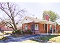 Red brick house with a carport and mature trees at 823 E Holly St, Rocky Mount, NC 27801