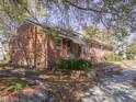 Brick house with landscaping and a large tree at 823 E Holly St, Rocky Mount, NC 27801