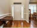 Bright entryway with hardwood floors, a drop-leaf table, and access to the dining room at 906 Trumpet Vine Ct, Wendell, NC 27591