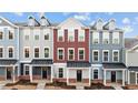 Three-story townhouses in a row, featuring a mix of gray and red siding at 121 Pearl St # 4, Garner, NC 27529