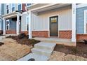 Townhouse front entrance with brick accents and a dark brown door at 121 Pearl St # 4, Garner, NC 27529