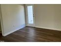Spare bedroom with wood-look flooring and door to backyard at 131 Tulipfield Way, Benson, NC 27504
