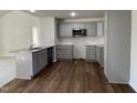 Modern kitchen with gray cabinets, granite countertops, and stainless steel appliances at 396 Magnolia Run Way, Benson, NC 27504