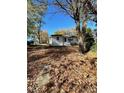 Attractive white house with large yard and mature trees at 445 N Dunn St, Angier, NC 27501
