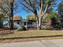 Front view of a charming white house with a spacious lawn at 445 N Dunn St, Angier, NC 27501